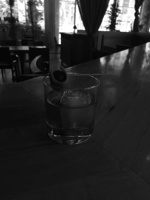 Smoked Old Fashioned served over a large clear cube with an expressed citrus peel