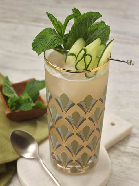 The Golden Hour in a deco patterned highball with cucumber ribbons and a mint bouquet