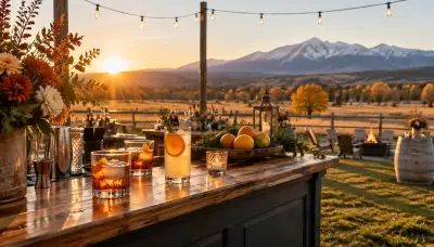 Mobile bar on a ranch venue lawn near Colorado Springs at golden hour with amber cocktails and Pikes Peak in the distance